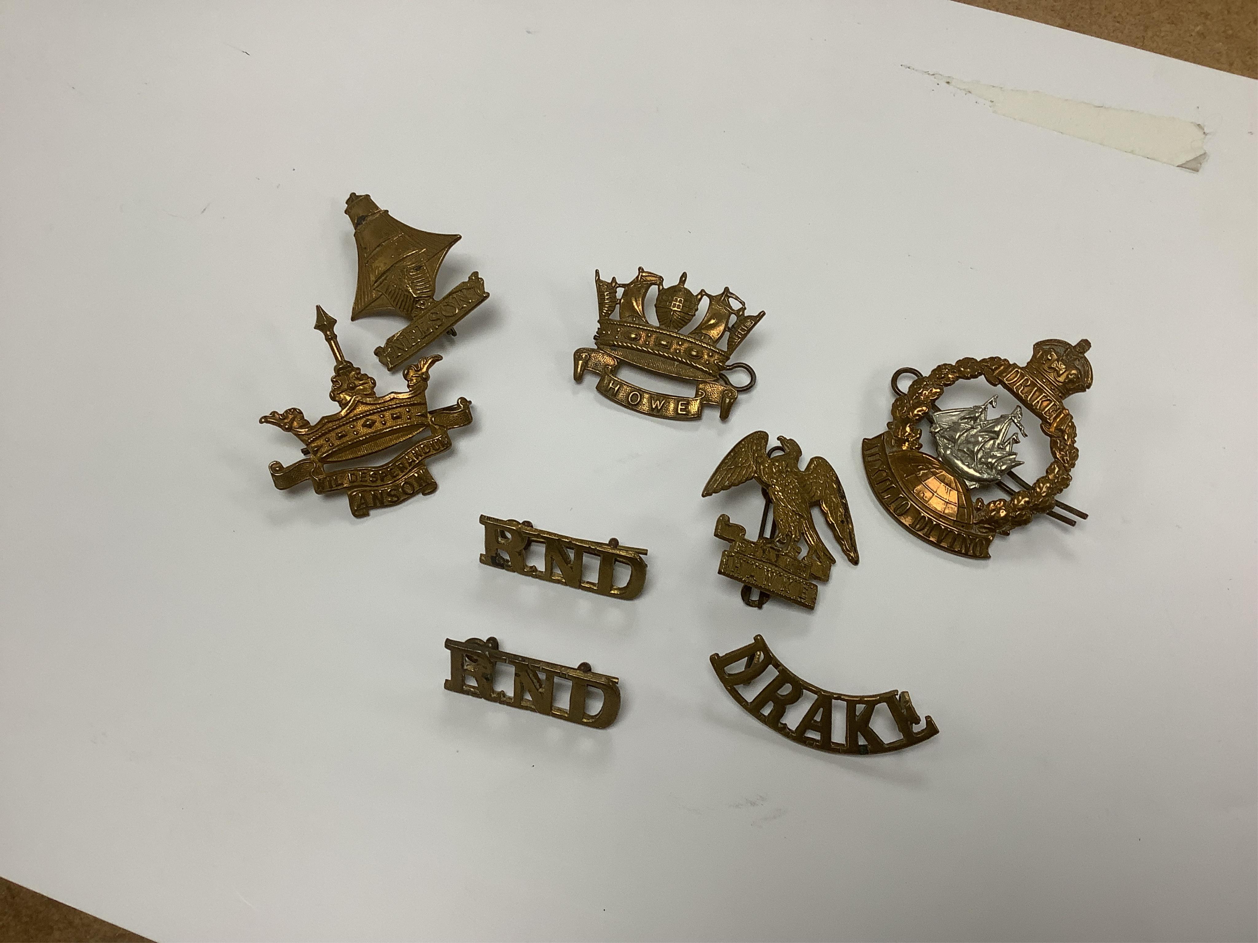 Five Royal Navy First World War brass cap badges; the Nelson, Hawke, Anson and Howe Battalions, together with three shoulder titles. Condition - fair, some possible restrikes.